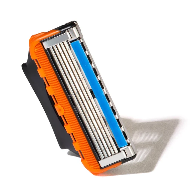Gillette razor blade with orange and black cartridge and blue lubricating strip.